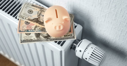 money and piggy bank on top of heater