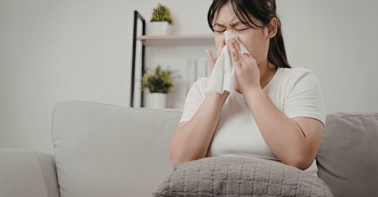 woman sneezing