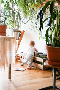 child next to a crate