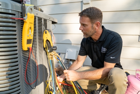 Patrick Chafin (GM) inspecting an outside AC unit.
