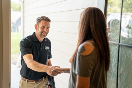 HVAC contractor shaking hands with a homeowner